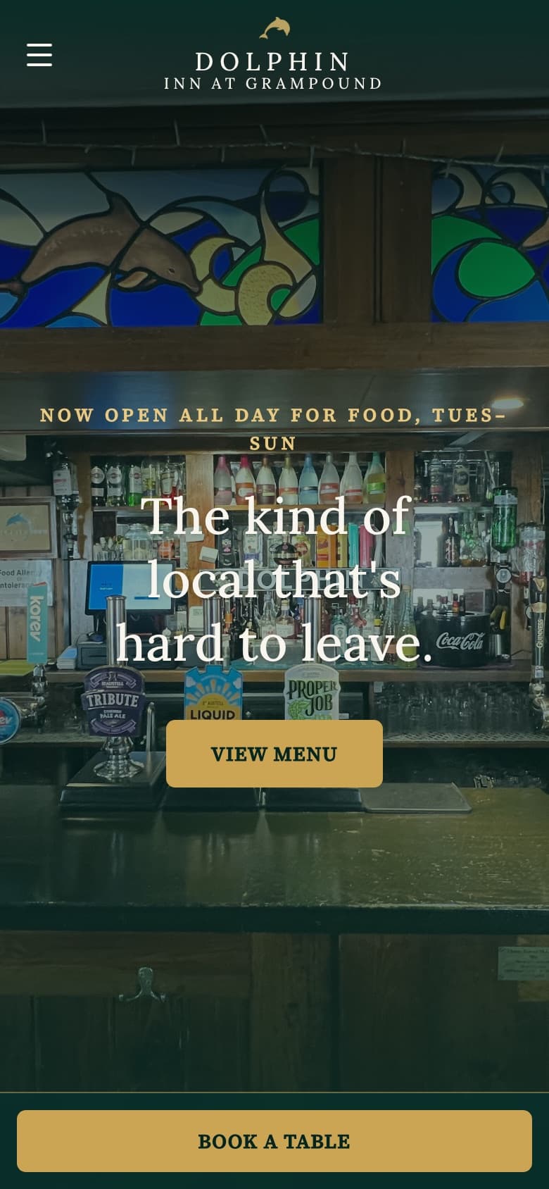 The Dolphin Inn website on a phone, with the Book a table bar